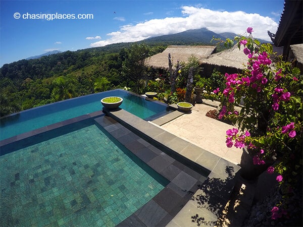 Rinjani Lodge's infinity pool greenery and Mount Rinjani in the background